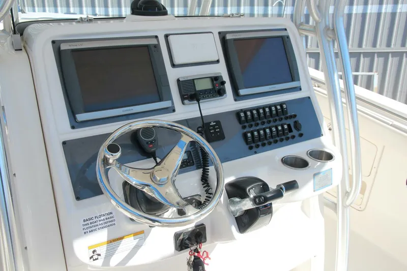 Slide: The Image of 2013 Robalo R300 Center Console dashboard with dual screens and steering wheel. - 3