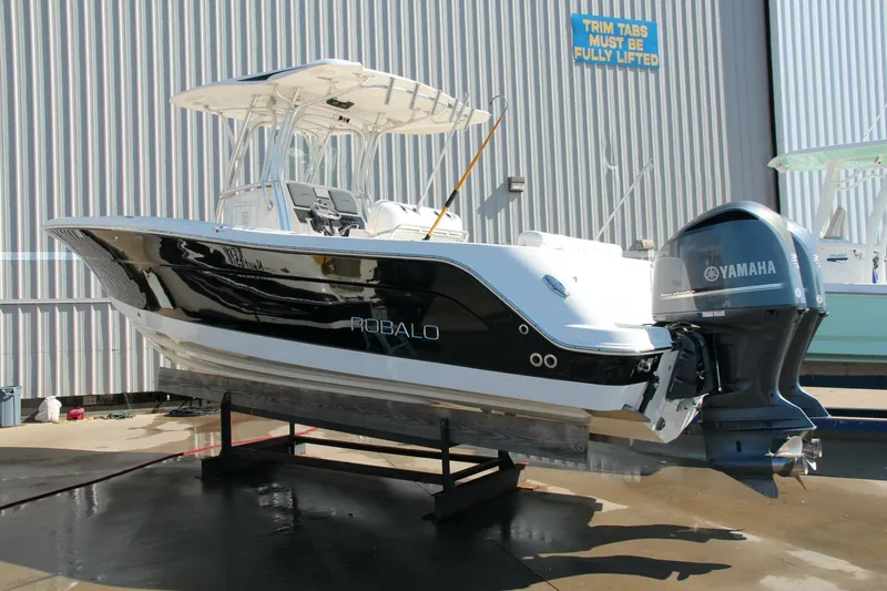 Slide: The Image of 2013 Robalo R300 Center Console boat with Yamaha engine, displayed on a stand. - 30