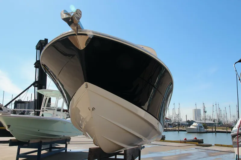 Slide: The Image of 2013 Robalo R300 Center Console boat docked at marina, viewed from front. - 31
