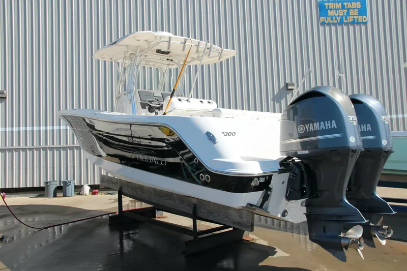 Slide: The Image of 2013 Robalo R300 Center Console boat with twin Yamaha engines on display. - 33