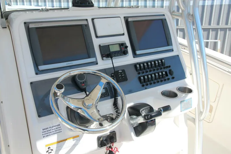 Slide: The Image of 2013 Robalo R300 Center Console dashboard with steering wheel and electronic controls. - 4
