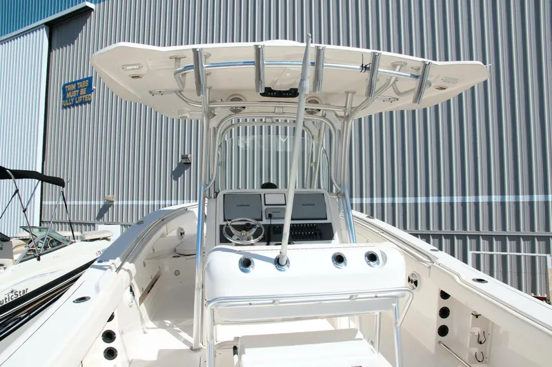 Slide: The Image of 2013 Robalo R300 Center Console boat with sleek design and modern controls. - 6