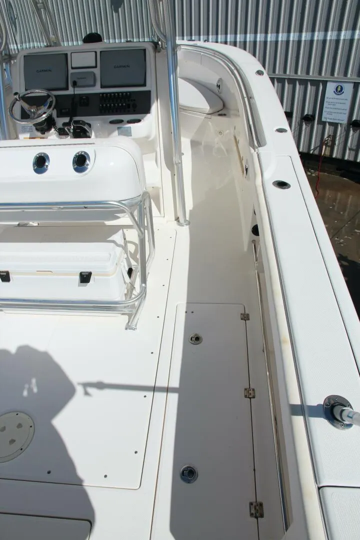 Slide: The Image of 2013 Robalo R300 Center Console boat deck with seating and control panel. - 8