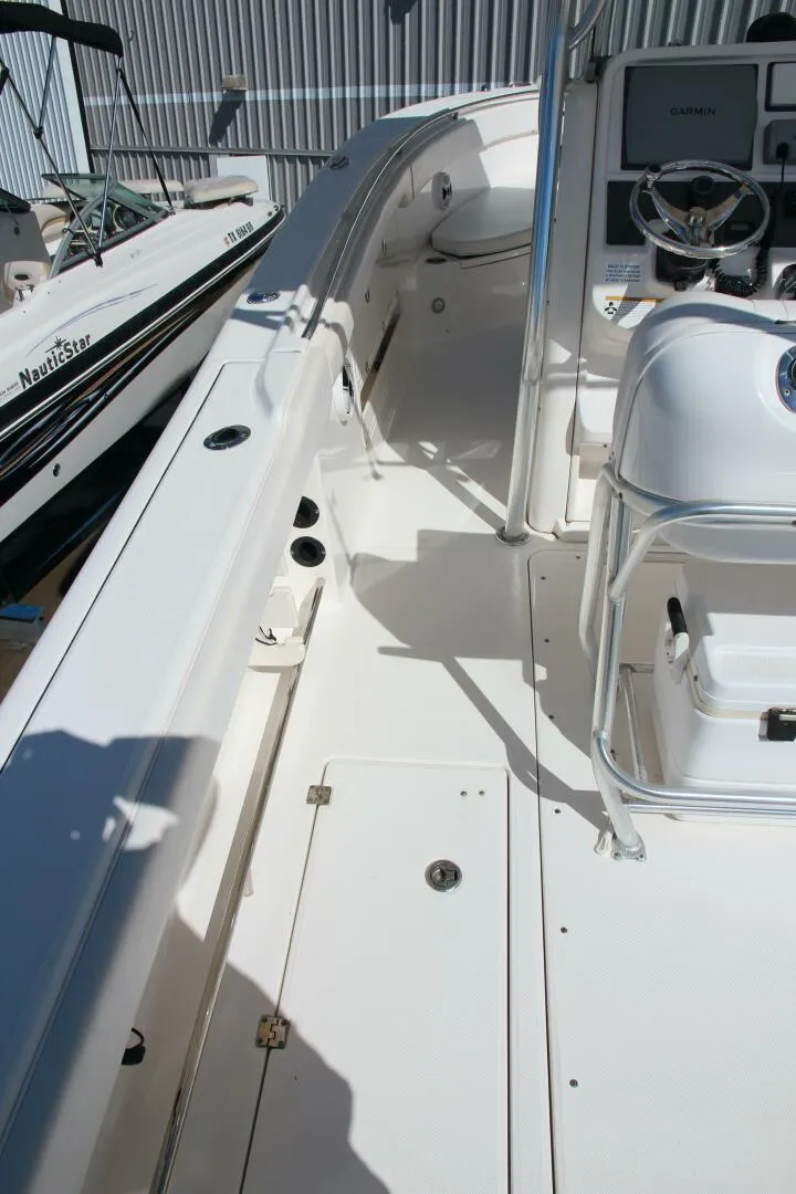 Slide: The Image of 2013 Robalo R300 Center Console boat interior with steering wheel and seating. - 9