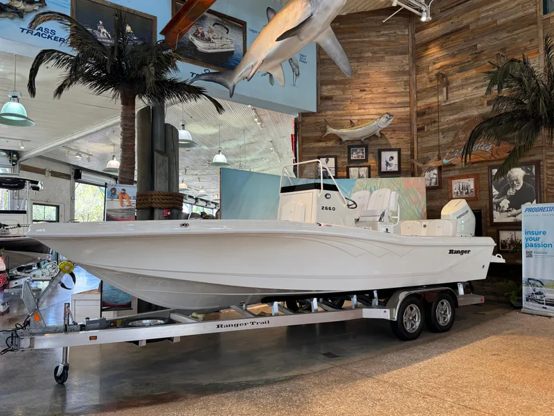 The Image of 2025 Ranger 2660 Bay boat displayed indoors on a trailer. - 0