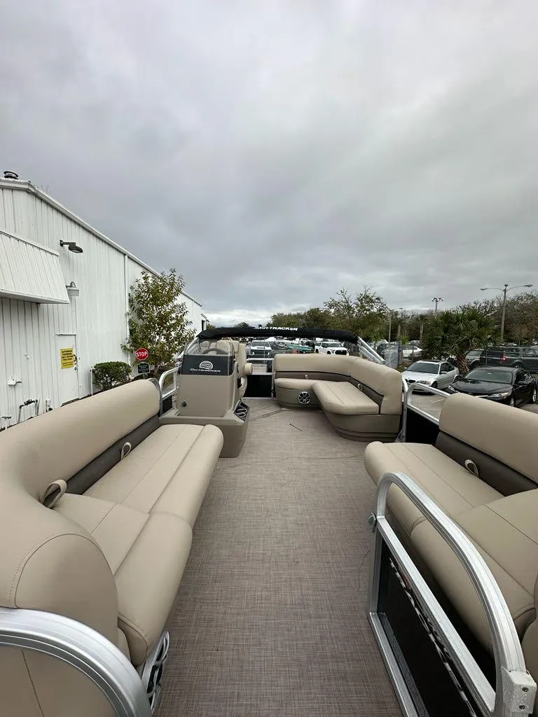 Slide: The Image of 2025 Sun Tracker Party Barge 16 DLX pontoon boat with spacious seating and modern design. - 2
