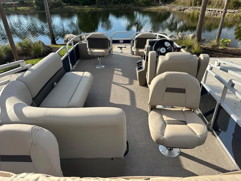 Slide: The Image of 2025 Sun Tracker Bass Buggy 18 DLX pontoon boat interior with beige seating. - 5