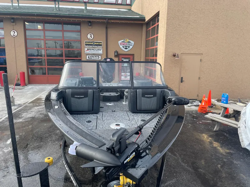 Slide: The Image of 2025 Tracker Targa V-19 WT boat displayed outside a dealership. - 2