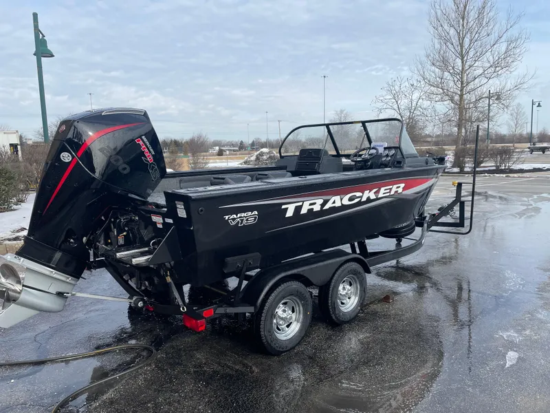 Slide: The Image of 2025 Tracker Targa V-19 WT boat on trailer, parked outdoors on a wet surface. - 3