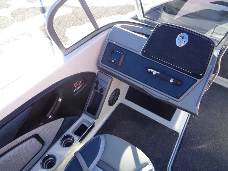 Slide: The Image of 2024 Ranger 1850MS boat interior with dashboard, seating, and cup holders. - 11
