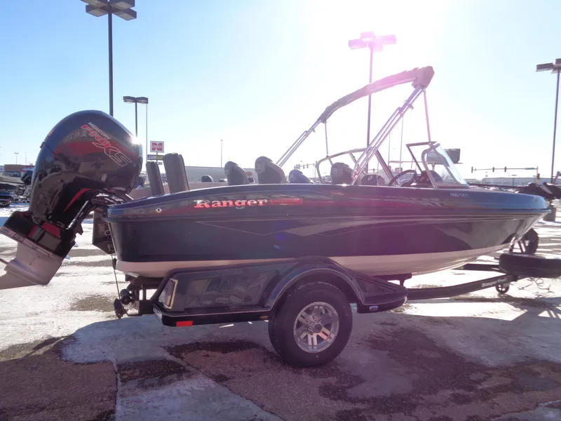 Slide: The Image of 2024 Ranger 1850MS boat with outboard motor on trailer, parked outdoors. - 5