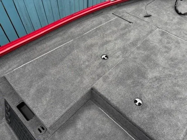 Slide: The Image of 2025 Tracker Savage 215 boat deck with gray carpet and red trim. - 10