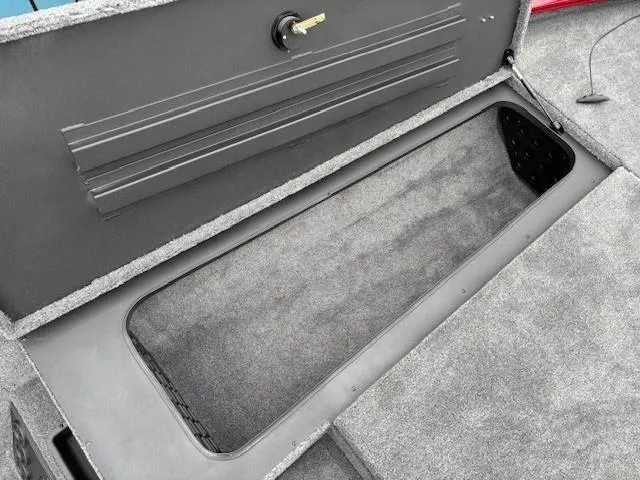 Slide: The Image of Storage compartment of 2025 Tracker Savage 215 boat, open and empty. - 11