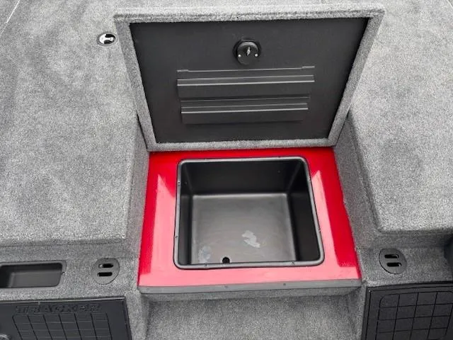 Slide: The Image of Tracker Savage 215 boat storage compartment, 2025 model, featuring a red and black interior. - 15