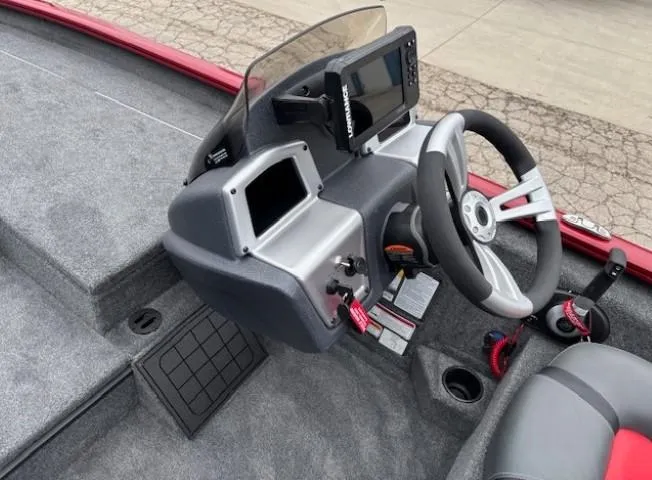 Slide: The Image of 2025 Tracker Savage 215 boat dashboard with steering wheel and electronic display. - 16