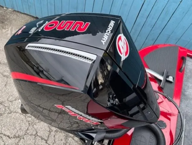 Slide: The Image of 2025 Tracker Savage 215 boat with Mercury engine, black and red design. - 29