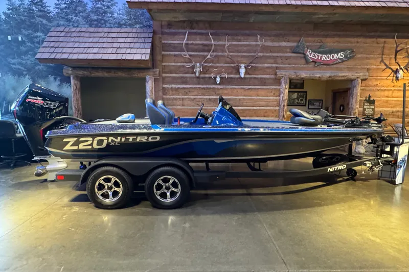 Slide: The Image of 2025 Nitro Z20 XL Pro boat displayed indoors, featuring sleek design and modern amenities. - 1