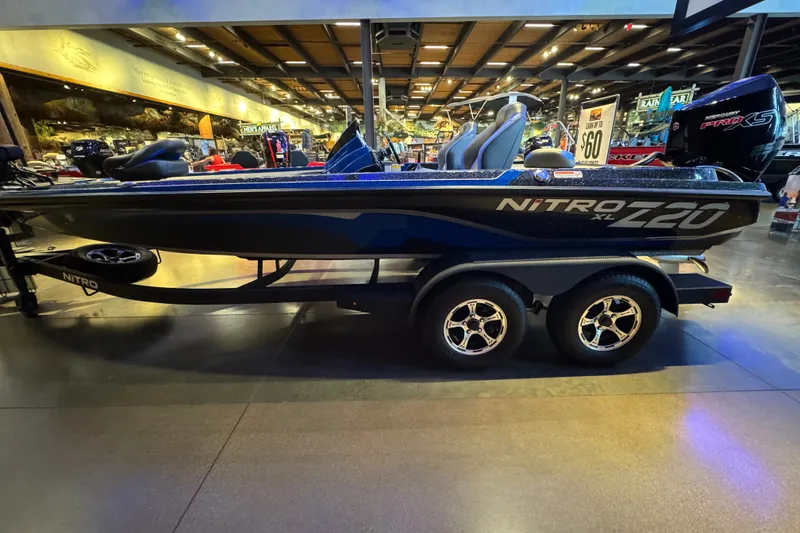 The Image of 2025 Nitro Z20 XL Pro boat displayed indoors with sleek design and dual-axle trailer. - 0