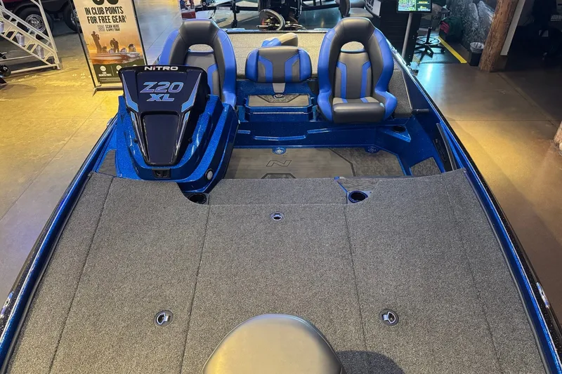 Slide: The Image of 2025 Nitro Z20 XL Pro boat interior with blue seats and spacious deck. - 10