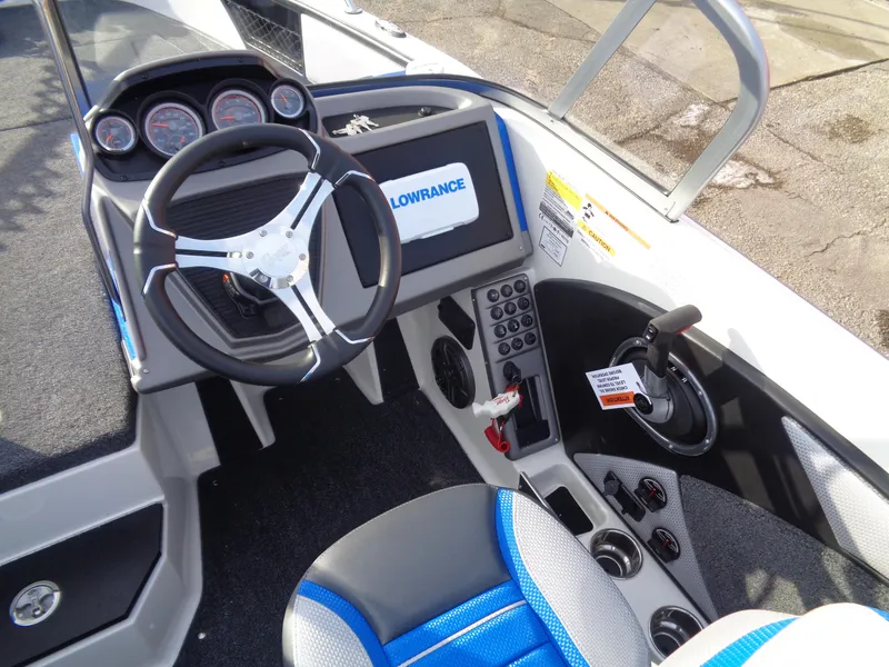 Slide: The Image of 2024 Ranger 1880MS boat cockpit with steering wheel, control panel, and Lowrance display. - 10