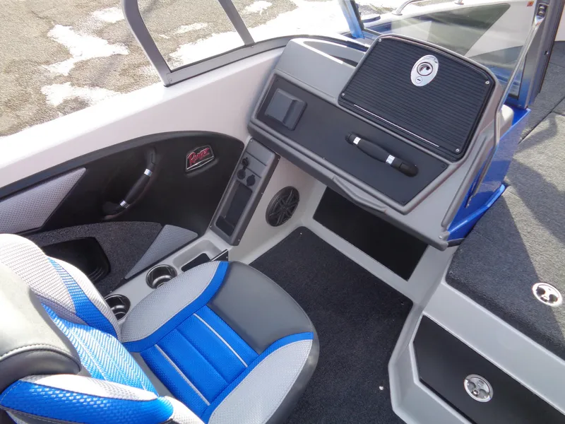 Slide: The Image of 2024 Ranger 1880MS boat interior with blue and gray seating, modern dashboard, and cup holders. - 11
