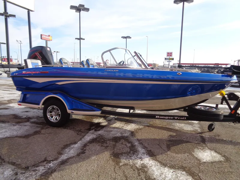 Slide: The Image of 2024 Ranger 1880MS boat in vibrant blue on a trailer, parked outdoors. - 5