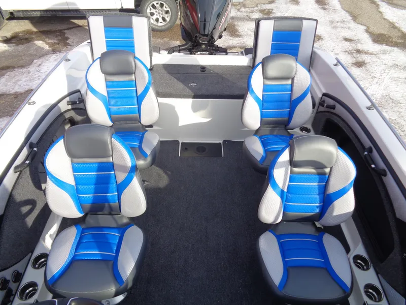 Slide: The Image of 2024 Ranger 1880MS boat interior with blue and gray seating arrangement. - 7