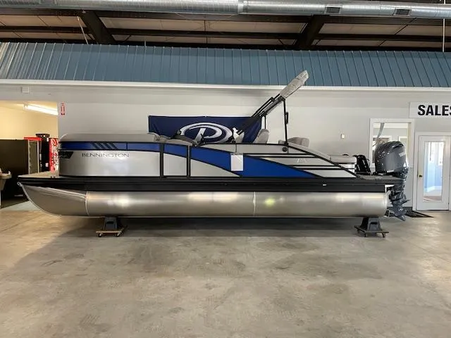 The Image of 2024 Bennington 23 LXSSB pontoon boat displayed indoors, featuring sleek design and modern features. - 0