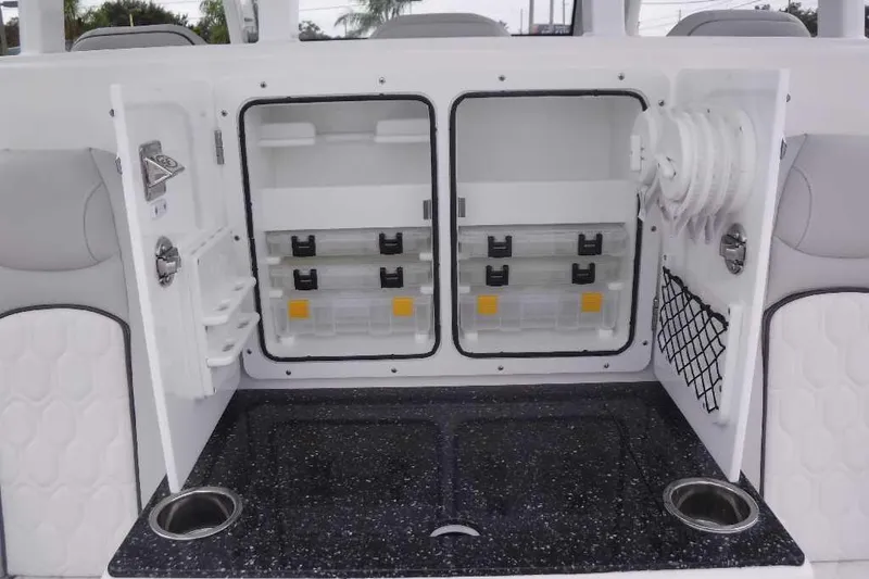Slide: The Image of 2020 Sea Fox 368 Commander storage compartment with tackle boxes and cup holders. - 10