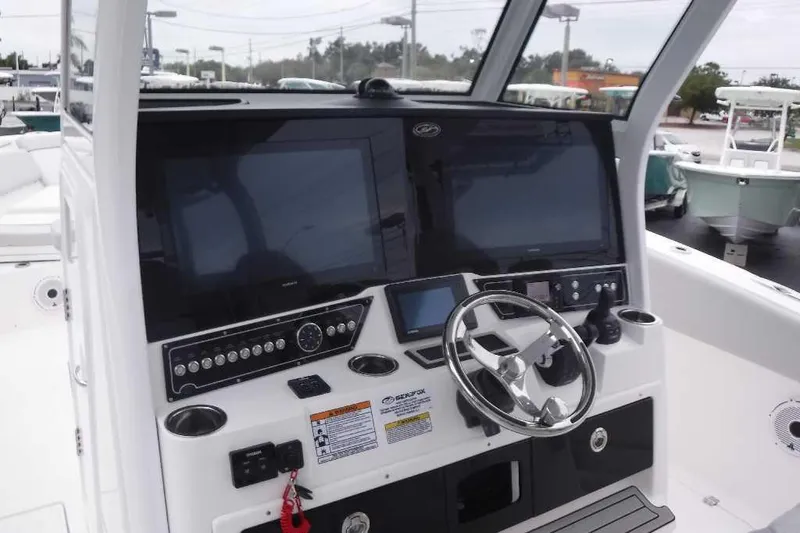 Slide: The Image of 2020 Sea Fox 368 Commander boat dashboard with dual screens and steering wheel. - 15