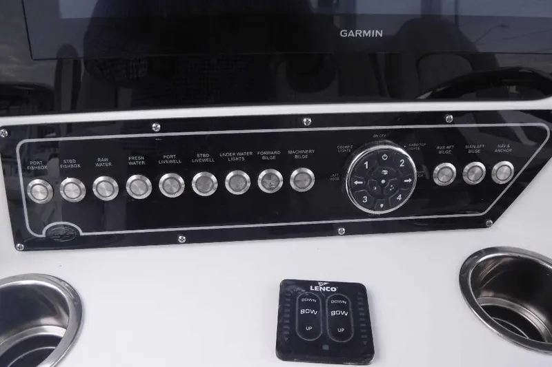 Slide: The Image of Control panel of 2020 Sea Fox 368 Commander boat with various switches and Garmin display. - 24
