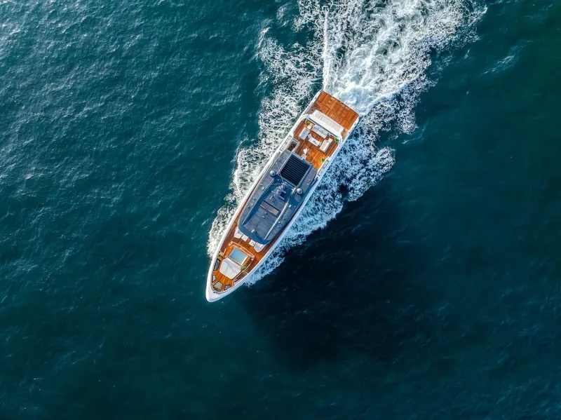 Slide: The Image of Aerial view of 2025 Majesty 100 Terrace yacht cruising on open sea. - 10