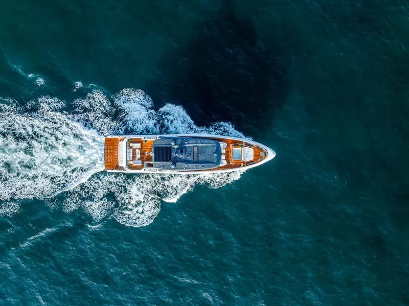 Slide: The Image of Aerial view of 2025 Majesty 100 Terrace yacht cruising through blue ocean waters. - 11
