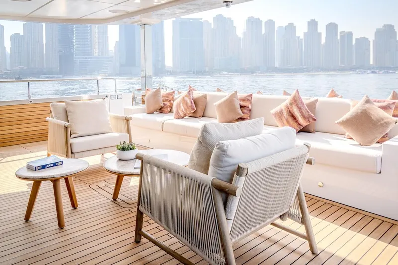 Slide: The Image of Luxurious 2025 Majesty 100 Terrace yacht deck with elegant seating and city skyline view. - 17