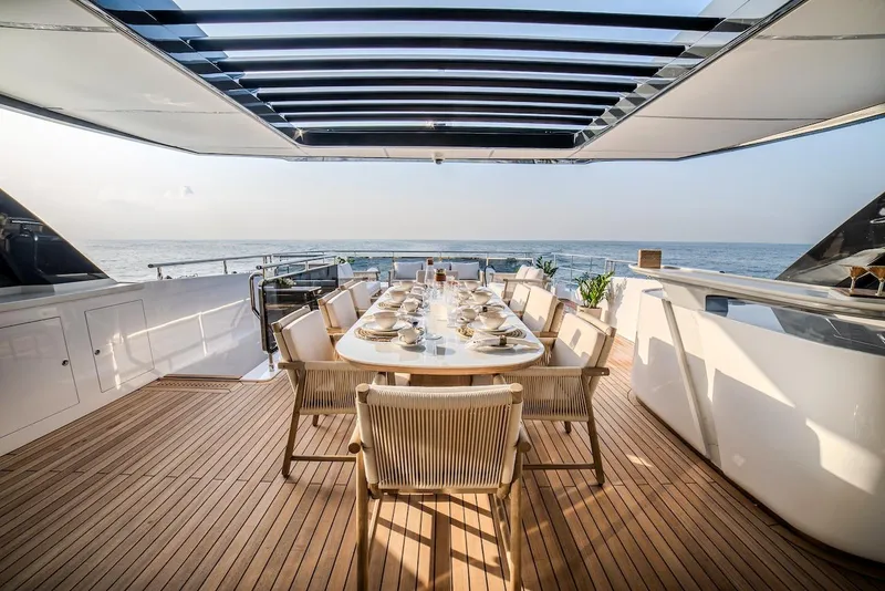 Slide: The Image of Luxurious dining area on 2025 Majesty 100 Terrace yacht with ocean view. - 21