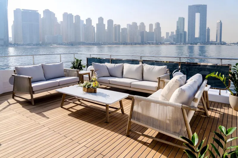 Slide: The Image of Luxurious 2025 Majesty 100 Terrace yacht deck with elegant seating, overlooking city skyline. - 24