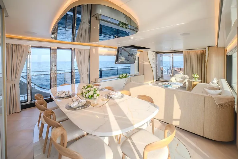 Slide: The Image of Luxurious interior of 2025 Majesty 100 Terrace yacht with elegant dining area and ocean views. - 26