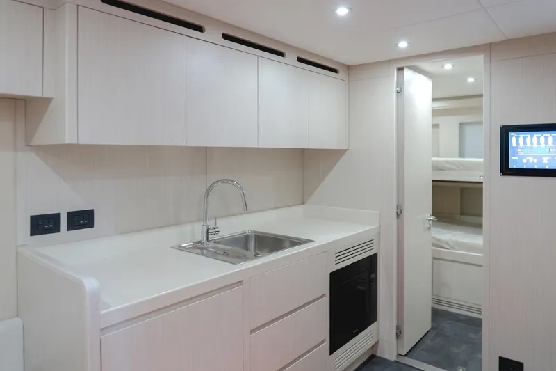 Slide: The Image of Modern kitchen interior in 2025 Majesty 100 Terrace yacht, featuring sleek cabinetry and integrated appliances. - 48