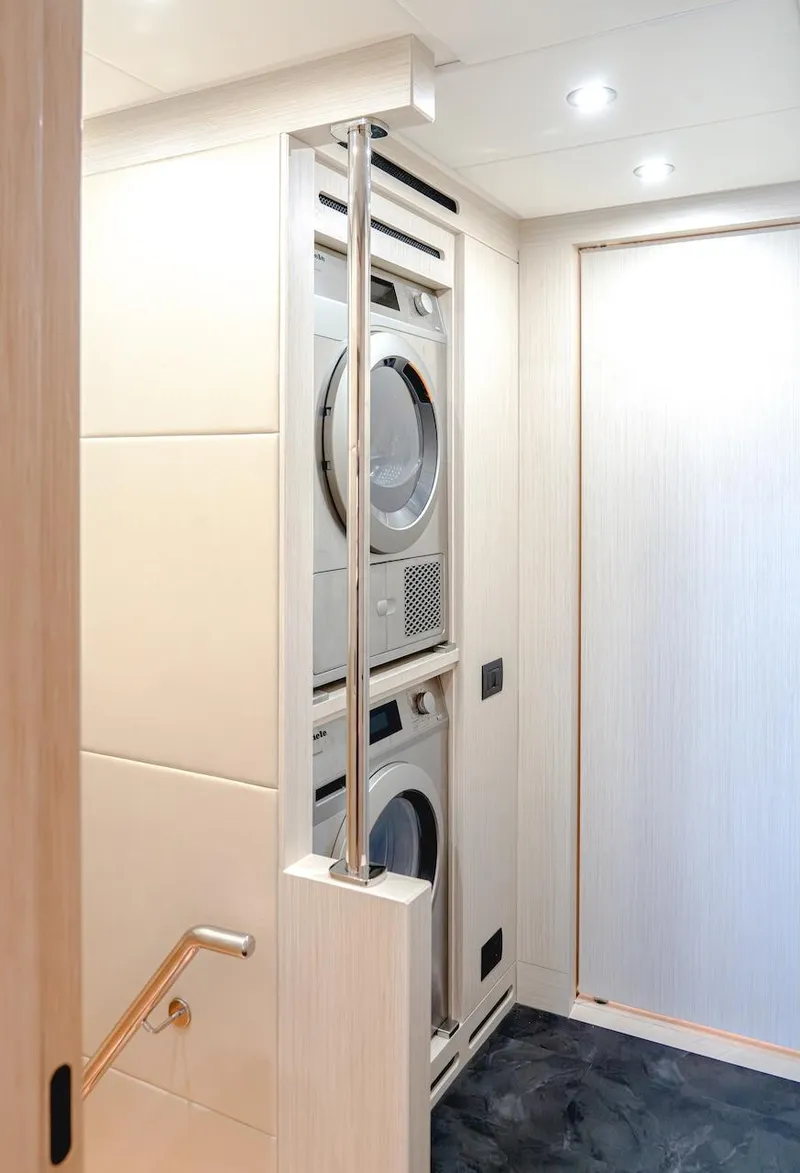 Slide: The Image of Modern laundry area in 2025 Majesty 100 Terrace yacht, featuring stacked washer and dryer. - 49
