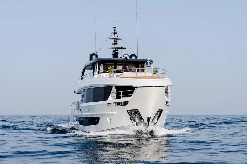 Slide: The Image of Majesty 100 Terrace 2025 yacht cruising on open sea, front view. - 6