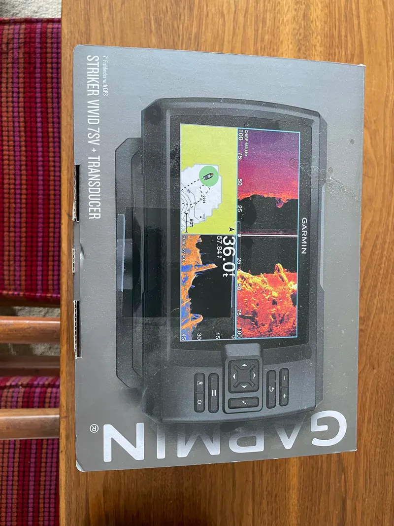 Slide: The Image of Garmin Striker Vivid 7SV Transducer box on wooden table, Tahoe 550 TS 2021 model. - 11