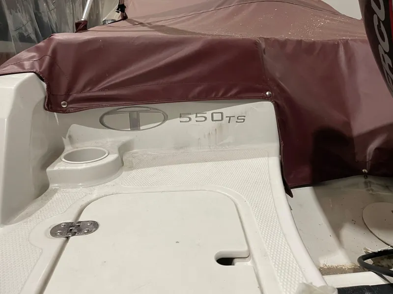 Slide: The Image of 2021 Tahoe 550 TS boat with maroon cover and white deck. - 3