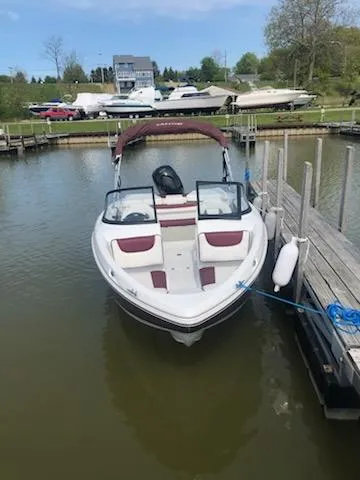 Slide: The Image of 2021 Tahoe 550 TS boat docked in a marina with other boats in the background. - 6
