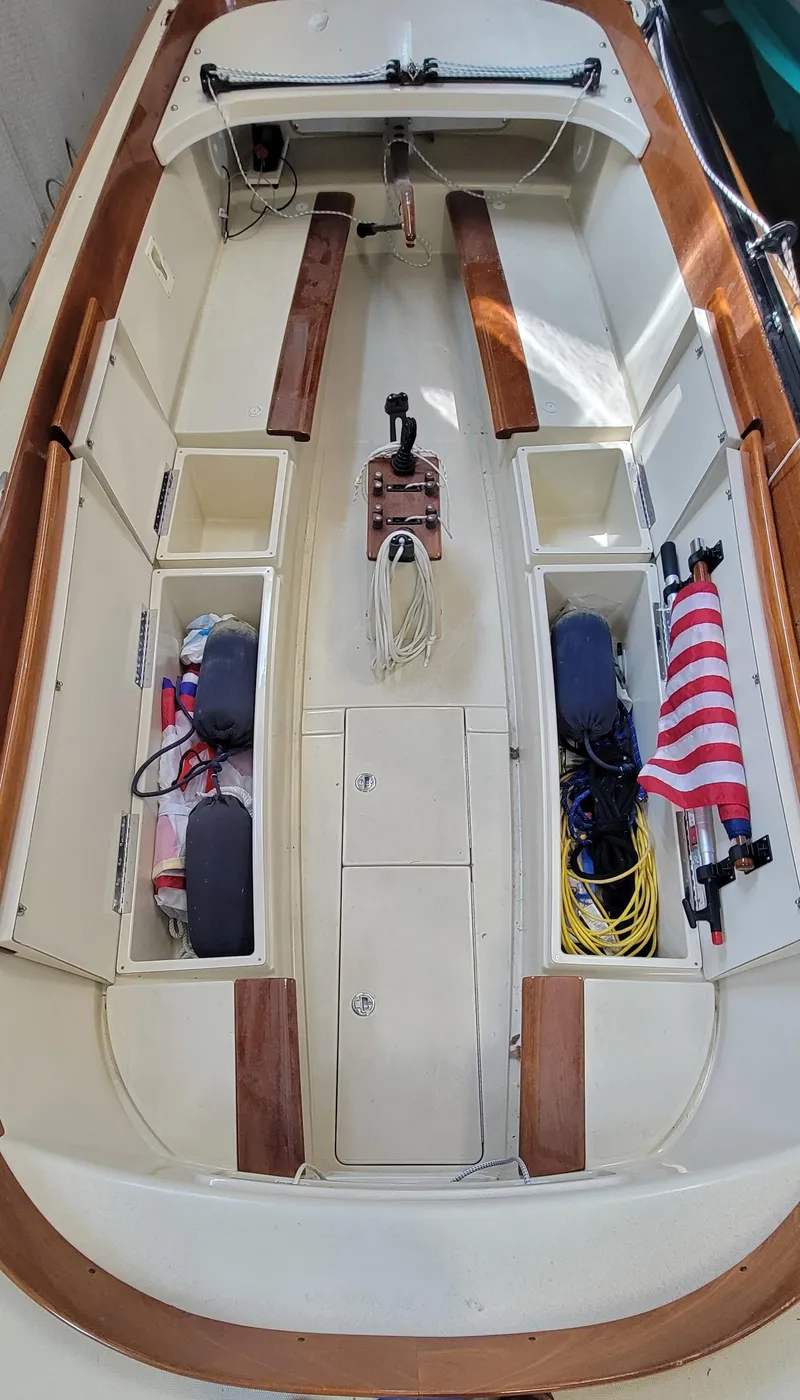 Slide: The Image of 2023 C.W. Hood 32 Daysailer interior with storage compartments and American flag. - 10