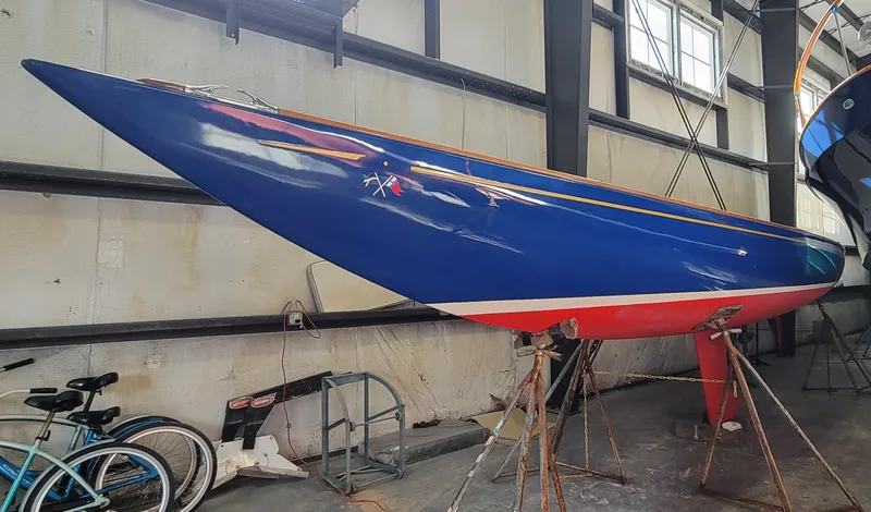 Slide: The Image of 2023 C.W. Hood 32 Daysailer in a workshop, featuring a sleek blue hull. - 2