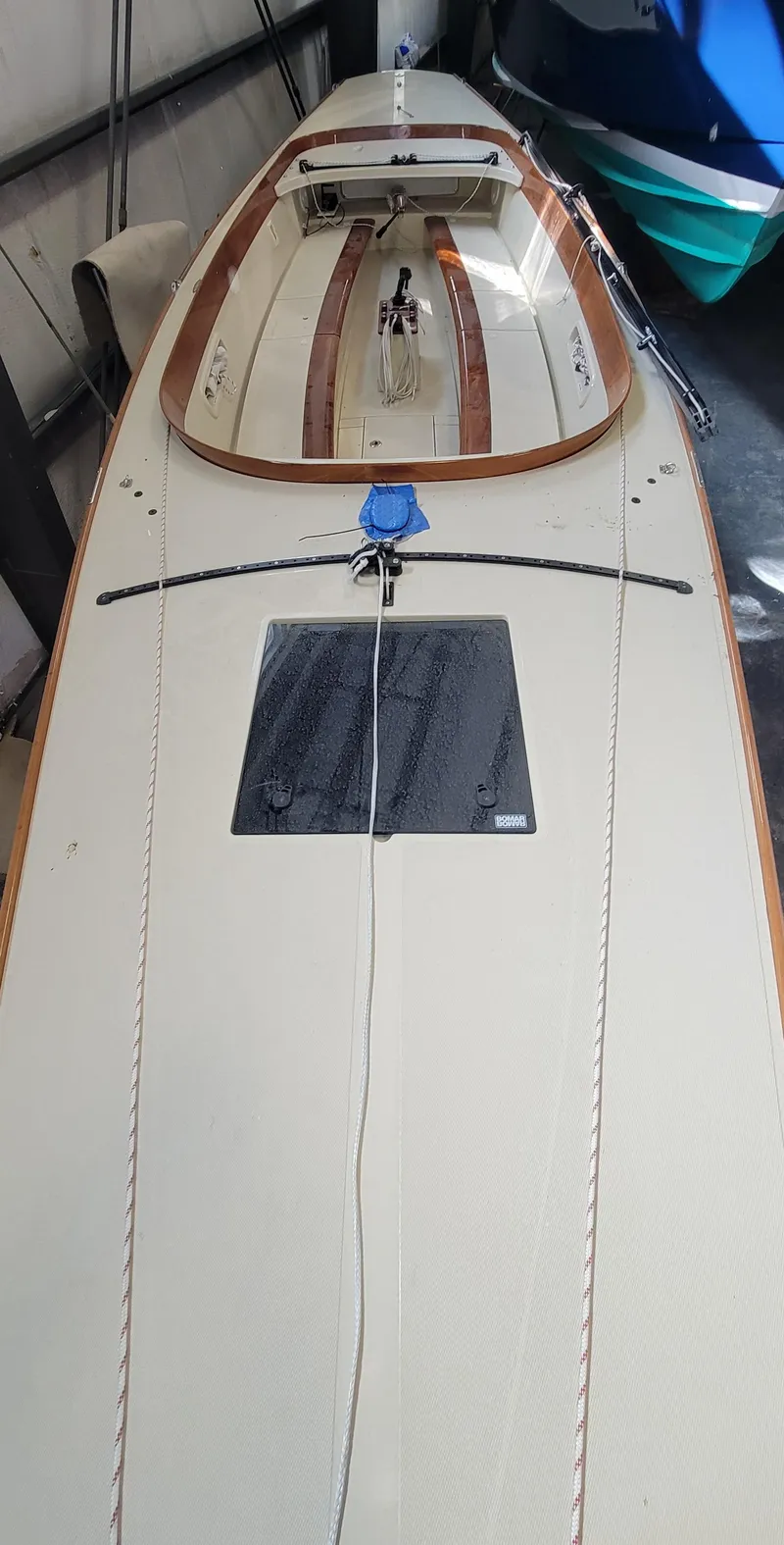 Slide: The Image of 2023 C.W. Hood 32 Daysailer with sleek deck design in a storage area. - 7