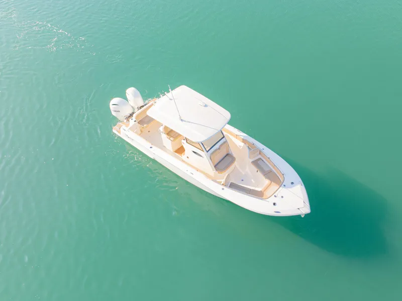 Slide: The Image of 2021 Scout 277 LXF boat on turquoise water, aerial view. - 10