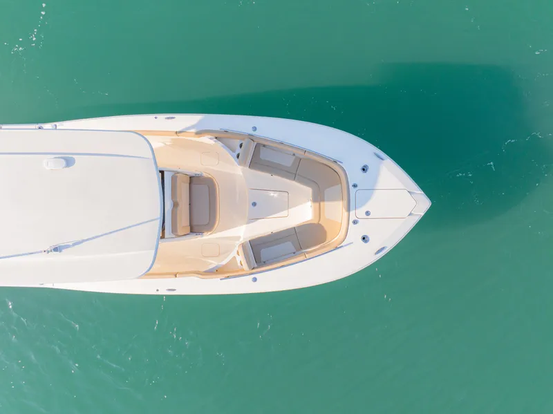 Slide: The Image of Aerial view of 2021 Scout 277 LXF boat on turquoise water. - 11