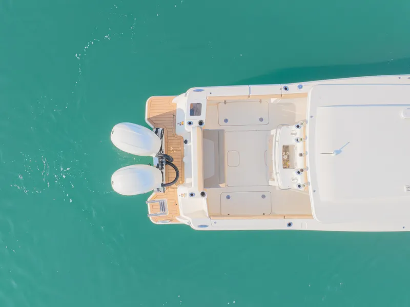 Slide: The Image of Aerial view of 2021 Scout 277 LXF boat on turquoise water. - 12