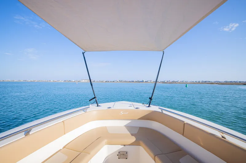 Slide: The Image of 2021 Scout 277 LXF boat with canopy on calm blue water. - 13
